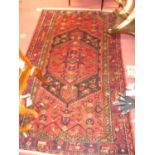 A Persian woollen red ground shiraz rug, 215 x 134cm