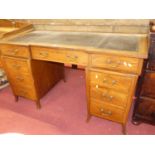 A circa 1900 mahogany and satin wood cross banded twin pedestal writing desk, having a rexine