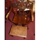 A Spanish stained beech X-frame elbow chair, with floral carved back, w.63.5cm; together with an oak