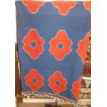 A Turkish woollen blue ground rug, having repeating red shaped flower head motifsWidth 150cm