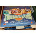 A boxed Tournament VC6000 video computer, containing a quantity of additional games to include