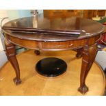 An early 20th century mahogany D-end extending dining table, having wind-out action, two extra