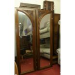 A late 19th century French floral relief carved walnut armoire, with twin bevelled mirrored doors (