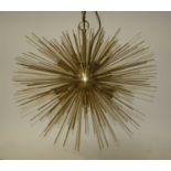 A contemporary gilt brass sunburst hanging ceiling light, having twelve baton lights surrounded by