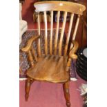 A stained elm and beech slat back farmhouse open armchair, width 56cm