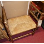 An early 20th century oak bobbin turned and rush seated side chair, width 55cm