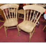 A set of four contemporary beech stick back kitchen chairs