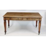 A William IV faded mahogany library table, having alternating real and dummy frieze drawers,