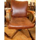 A 1930s oak framed and tan leather studded upholstered swivel desk elbow chair, width 58cm