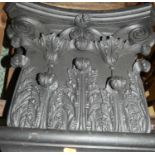 A pair of contemporary black painted and carved hardwood wall mounted composition capitals, each