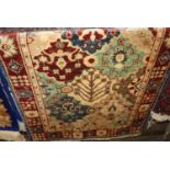 A Persian woollen cream ground Tabriz rug, 135 x 63cm