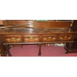 An 18th century oak ledgeback long dresser base, having four frieze drawers on fret cut forelegs,