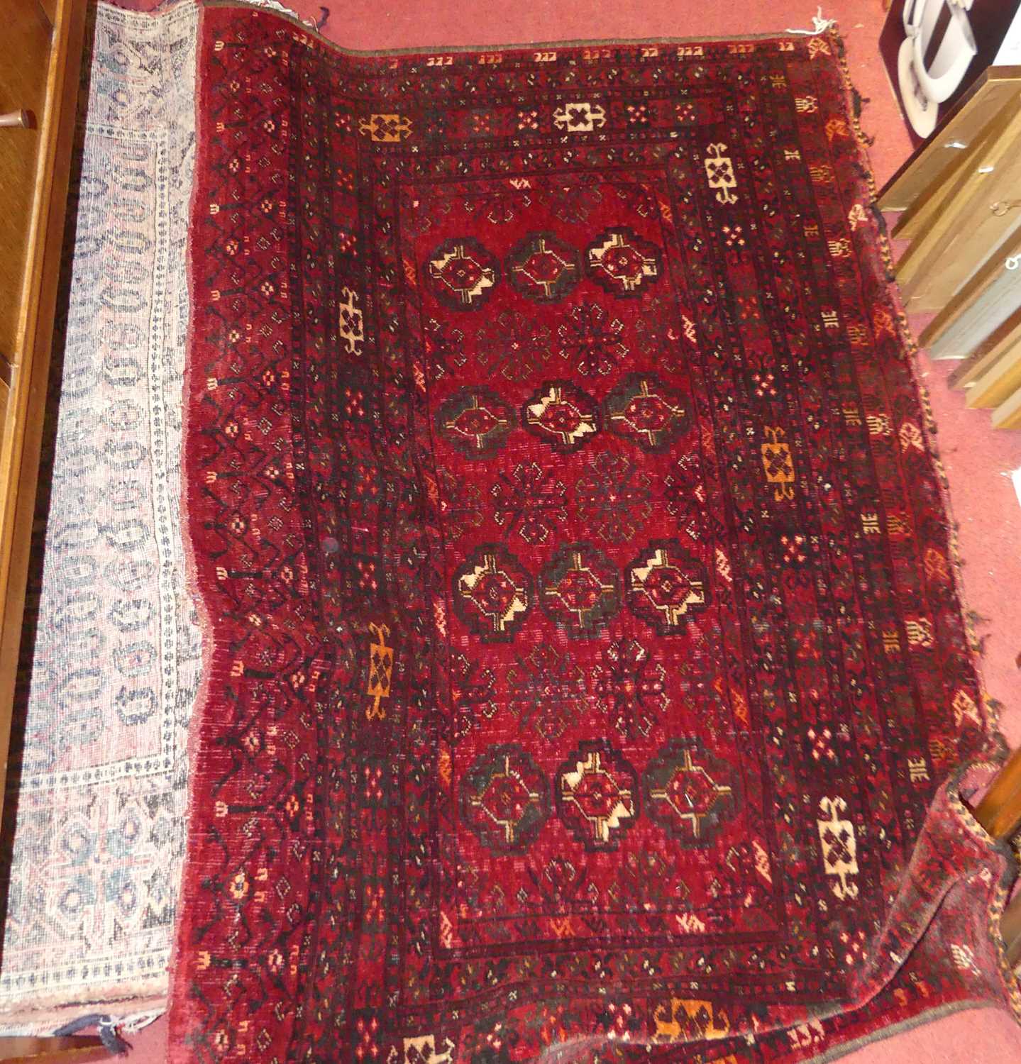 Three various Persian woollen rugs to include; red ground Bokhara example