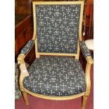 An early 20th century French floral gilt wood framed and reupholstered fauteuil, raised on turned