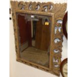 A faded floral carved oak bevelled rectangular wall mirror, 90 x 72cm