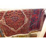 Two similar small Persian hall rugs, each with floral geometric ground