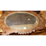 A circa 1900 mahogany fret cut bevelled oval wall mirror, 87 x 49cm