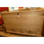 A rustic reclaimed pine hinge top mule chest, with iron end carry handles, width 95cm