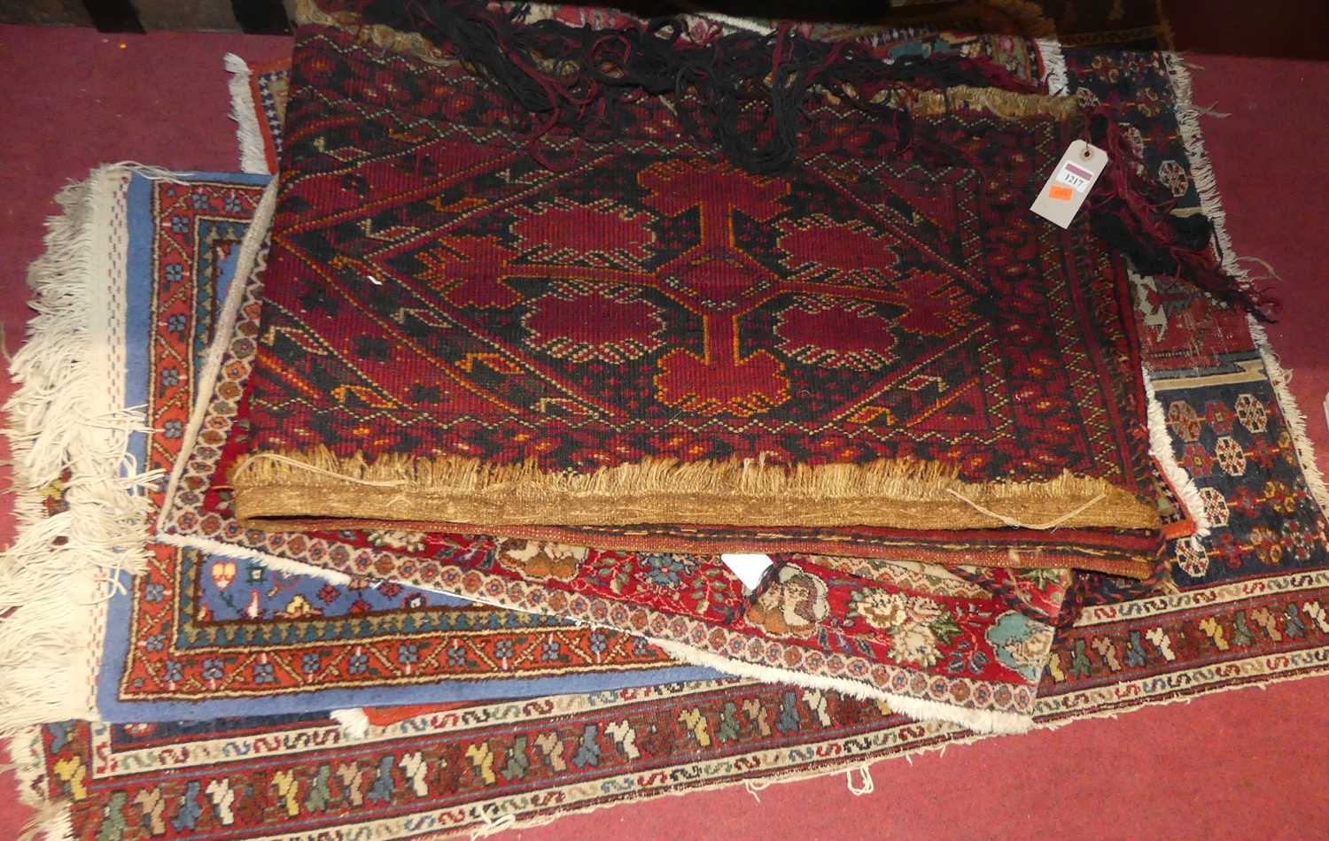 A collection of seven various Persian and other woollen hall rugs