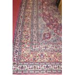 A Persian woollen blue and red ground Tabriz rug, having multiple trailing tramline borders (wear