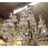 A good quality contemporary cut crystal glass and polished brass twelve-light hanging chandelier,