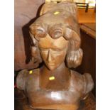 A rustic Italian stained and carved hardwood bust of a woman (comprised of two parts), height 46cm