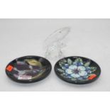 Two contemporary Moorcroft pin trays, dia.12cm; together with a Swarovski crystal dolphin group, h.