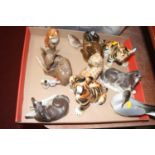A collection of assorted continental porcelain figures to include Lomonosov model of a seated fox, a
