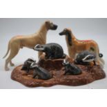 A Beswick group of five badgers upon a naturalistic base, w.29cm; together with a Beswick dog