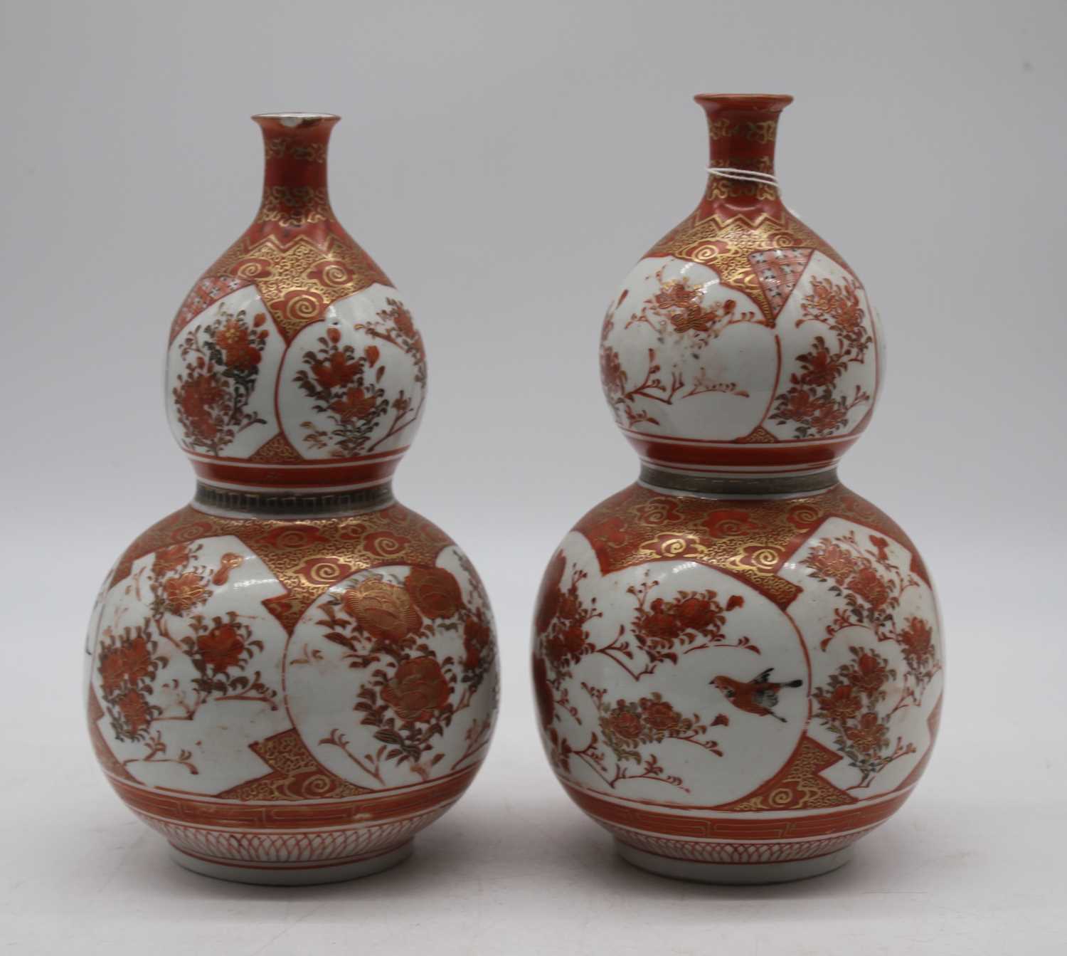 A pair of Japanese Meiji period Kutani double gourd vases signed verso, height 23cmBoth damaged