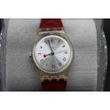 A ladies 9ct gold cased manual wind wrist watch having unsigned white enamel dial together with