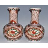 A pair of Chinese Wucai vases, each having a flared rim to a tapering neck and bulbous lower body,