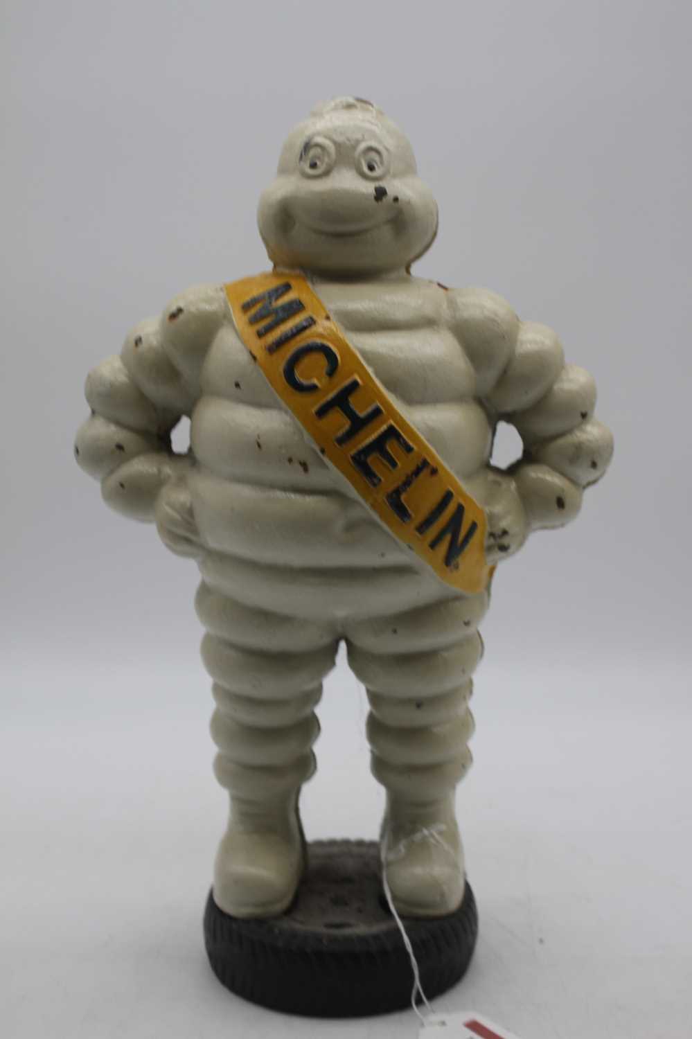 A reproduction painted cast iron Michelin Man figure, height 37cm