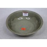 A Chinese celadon glazed stoneware footed bowl, h.19cm