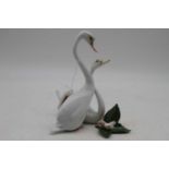 An Herend porcelain swan group, No.5192/C, h.19cm; together with an Herend porcelain figure of a