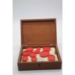 A collection of 19th century Grand Tour wax seals, depicting classical scenes, housed in a 19th