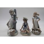 A Lladro porcelain figure group of a girl at the waterpump, h.23cm; together with two others (3)
