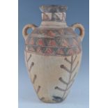 A large pottery twin handled vase of amphora shape, with traditional brushed painted bi-chrome