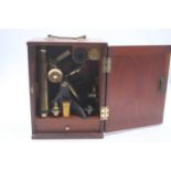 A circa 1900 lacquered brass monocular microscope with some accessories in fitted mahogany box