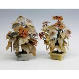 A pair of Chinese polished hardstone jardinieres of flowers, the flowerheads of varying hues