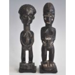 A pair of ancesestor figures, carved as a male and female in standing pose, finished in natural palm