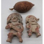 A Central/South American pottery grotesque figure, h.25cm; together with one other smaller, h.