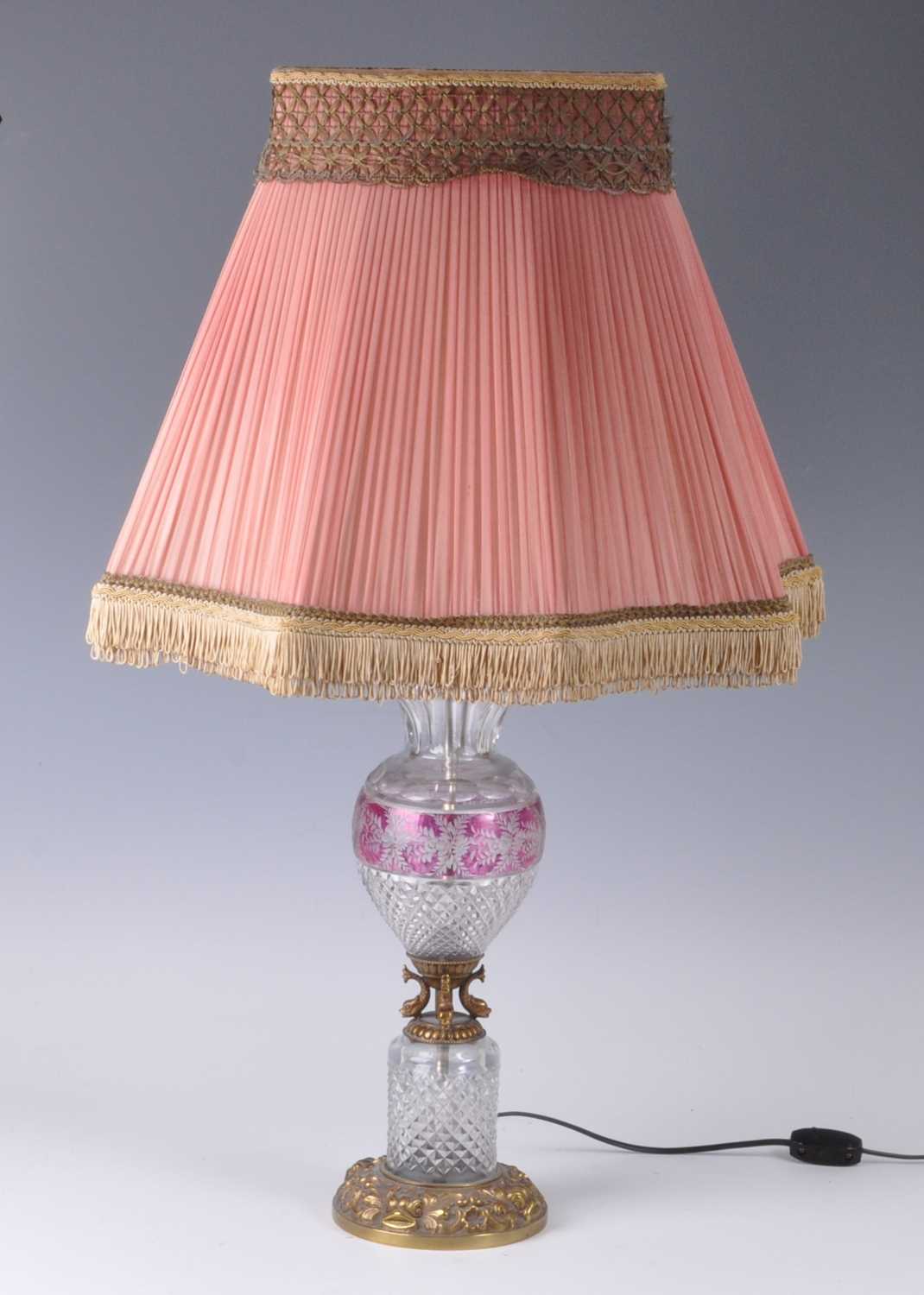 A 20th century cut crystal and gilt metal table lamp, of baluster form, the pleated shade above a