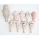 A collection of nine Chinese moulded pottery funeral figure heads, several with remains of