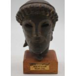 A Greek terracotta head of Zeus mounted on stand together with a museum replica group pottery urn,