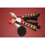 A childs soft toy of a Mexican dancer