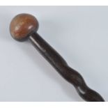 A carved ironwood knobkerrie, having a typical bulbous head on a helix shaped shaft, Zulu People,