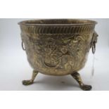 A Regency style brass jardiniere, repoussee decorated with heraldic lions, height 26cmQuiet