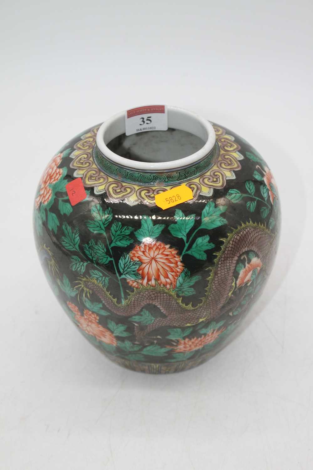 A reproduction Chinese famille noir vase of squat baluster form