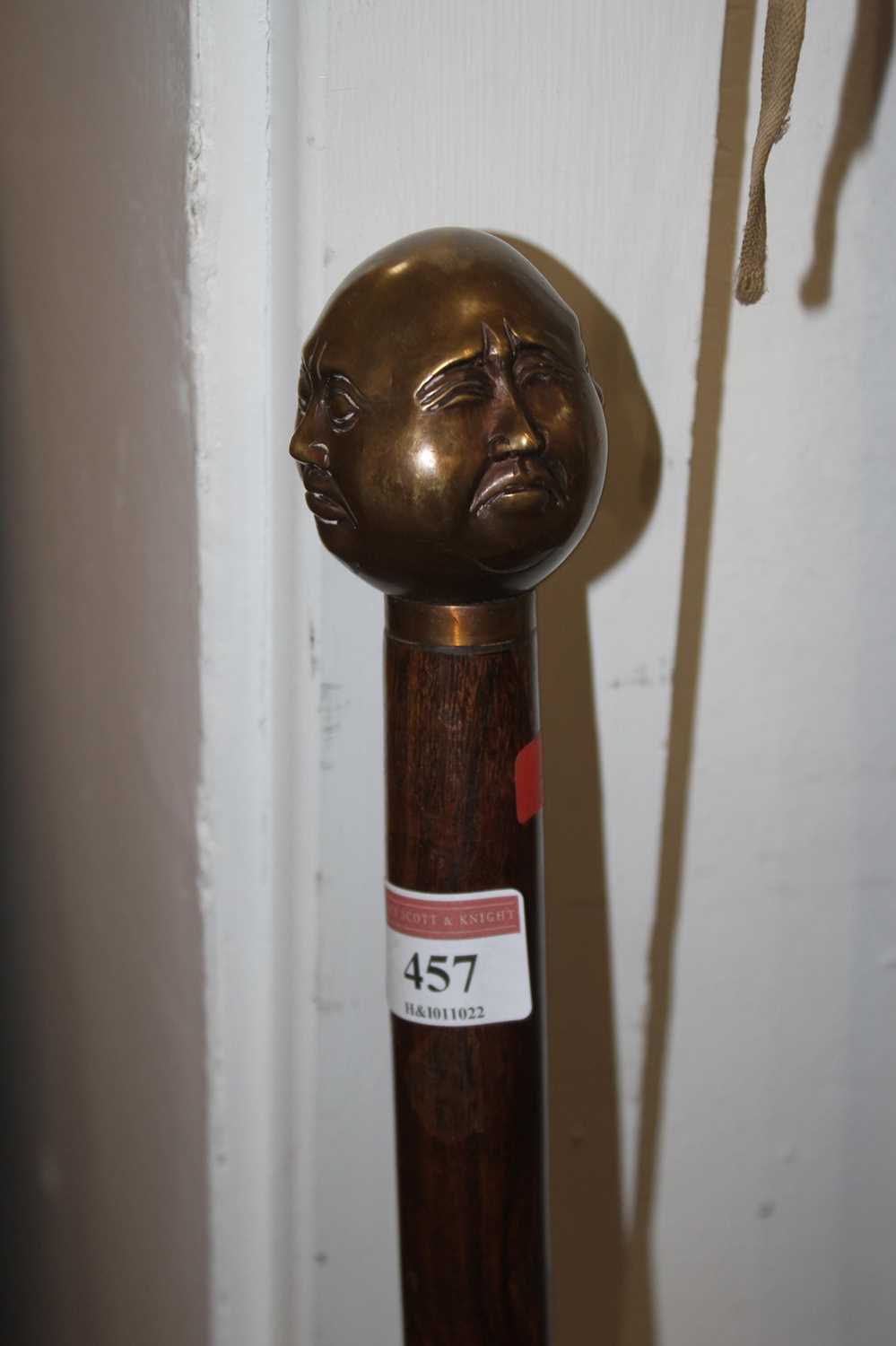 A Chinese 'rosewood' and brass four head topped walking cane, 92cm